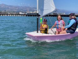 Sabot sailors defending their craft with a water cannon
